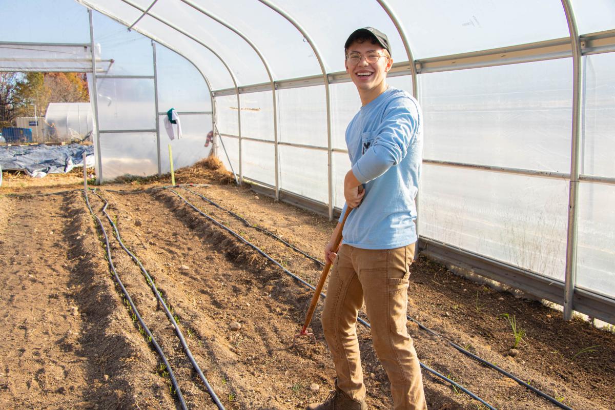 Harrison Hula hoeing in the hoop house